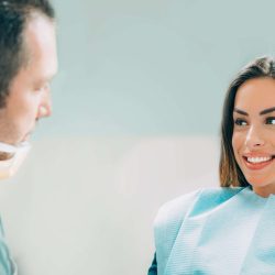 Young smiling woman with beautiful teeth, having a dental inspection
